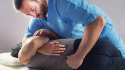Denver chiropractor adjusting a patient with back pain